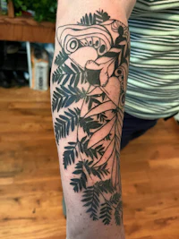 a black and white tattoo of a bird and leaves