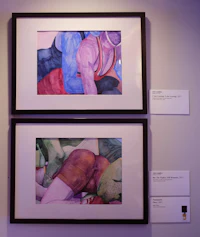 two framed paintings of a woman and a man on a wall