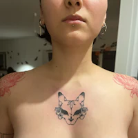 a woman with a tattoo of a cat on her chest