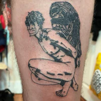 a tattoo of a man with an angel on his thigh