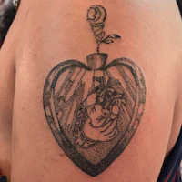 a woman with a tattoo of a heart on her shoulder