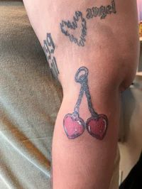 a woman with a tattoo of two hearts on her arm