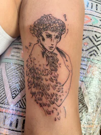 a tattoo of a woman with wings on her thigh