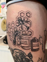 a tattoo of a bee on a person's arm