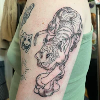 a tattoo of a tiger on a woman's arm