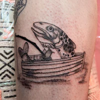 a tattoo of a fish in a boat