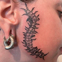a woman with a tattoo on her ear