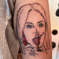 a tattoo of a woman with a cigarette on her arm